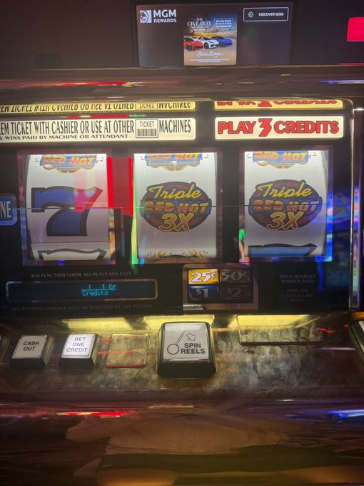 A close-up of a slot machine displaying "Triple Red Hot 3X" symbols, including the number 7, alongside "PLAY 3 CREDITS" signage. The "Wow" caption reflects the excitement of hitting a winning combination with multiple 7s and Triple Red Hot 3X symbols lined up across the reels.