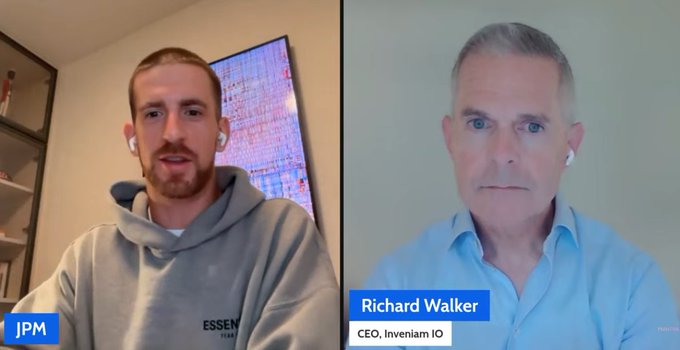 A split-screen video call interview between a man in a gray 'ESSENTIALS' hoodie labeled 'JPM' on the left, and Richard Walker, CEO of Inveniam IO, wearing a blue shirt on the right.