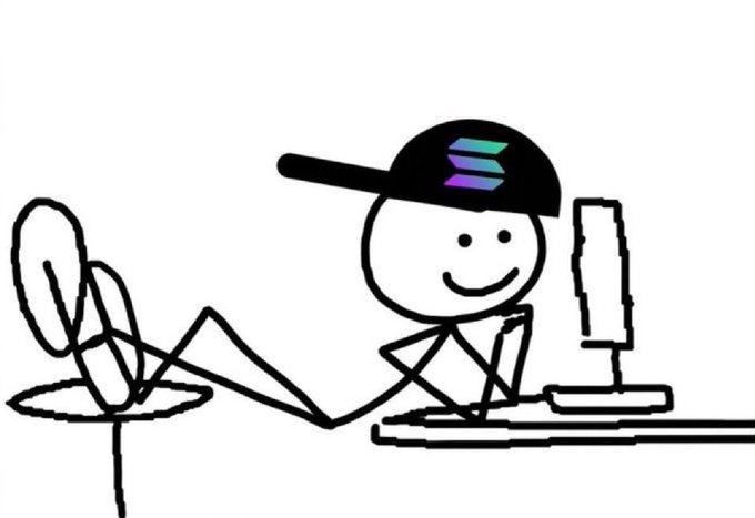 A simple line drawing of a smiling stick figure wearing a backward cap with a colorful logo, sitting at a desk using a computer with their feet up.
