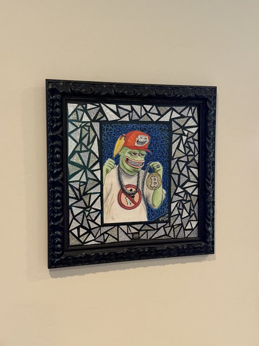 A framed mosaic-style artwork depicts a green-skinned character wearing a red cap and a chain with a "B" pendant.