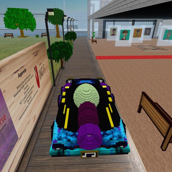 A voxel/blocky-style 3D rendering of a colorful car parked on a wooden boardwalk near a sign labeled 'Agenda' listing topics like 'Metaverse architecture' and 'NFT creation'.