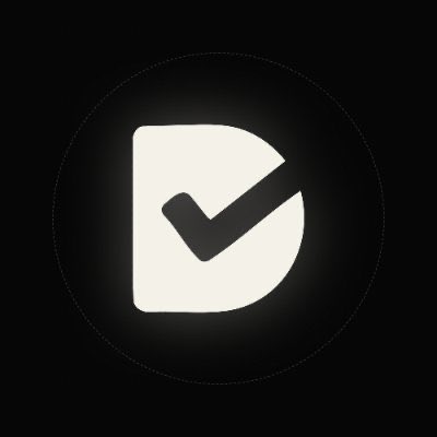 A minimalist logo featuring a white shield shape containing a black checkmark on a dark gray background.
