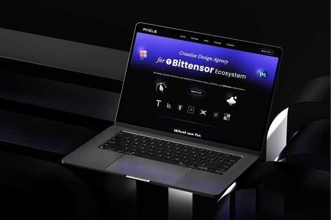 A dark-themed laptop displaying the Pexels website homepage for a 'Creative Design Agency for Bittensor Ecosystem', resting on a black surface.