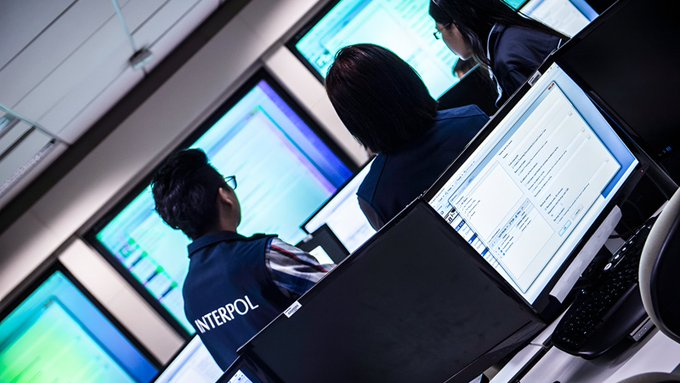 INTERPOL agents analyze digital displays in a high-tech operations center, working to combat the global surge in social engineering fraud that has impacted over 142,000 victims across 97 countries, as highlighted in their recent anti-cybercrime initiative.