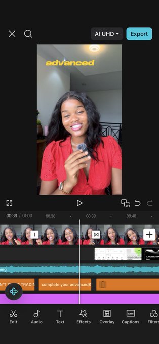 Screenshot of a video editing app showing a young woman in a red top holding a small object, with the word "advanced" displayed on screen and a timeline visible below.