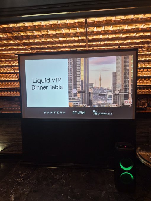 A presentation screen in an upscale venue displaying 'Liquid VIP Dinner Table' alongside city skyline visuals and sponsors 'PANTERA', 'Multipli', and 'yieldbasis' at the bottom.