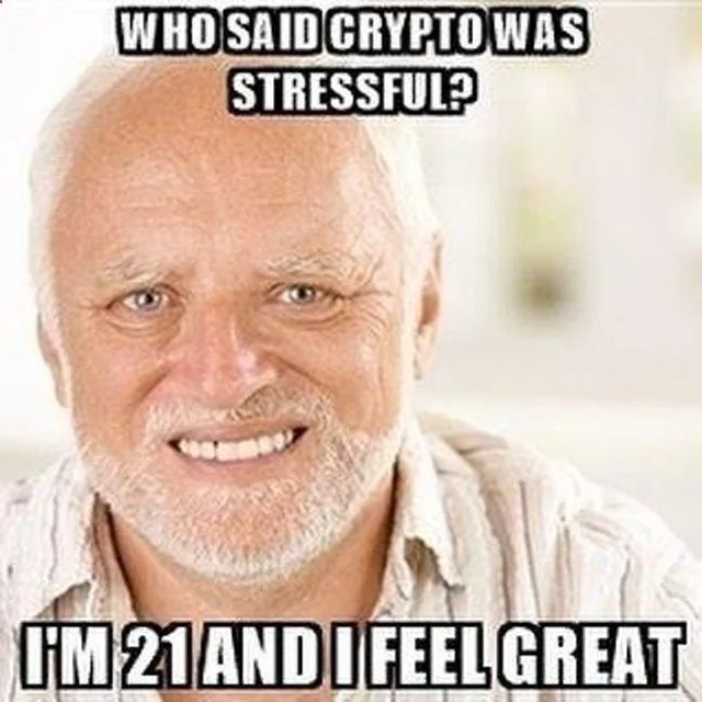 The image is the "I'm 21 and I feel great" meme, featuring a smiling older bald man with the text "WHO SAID CRYPTO WAS STRESSFUL?" at the top and "I'M 21 AND I FEEL GREAT" at the bottom. It humorously contrasts the relatable stress of crypto trading (referenced in the post) with the meme's ironic claim of feeling great, poking fun at how crypto investors cope with market volatility.