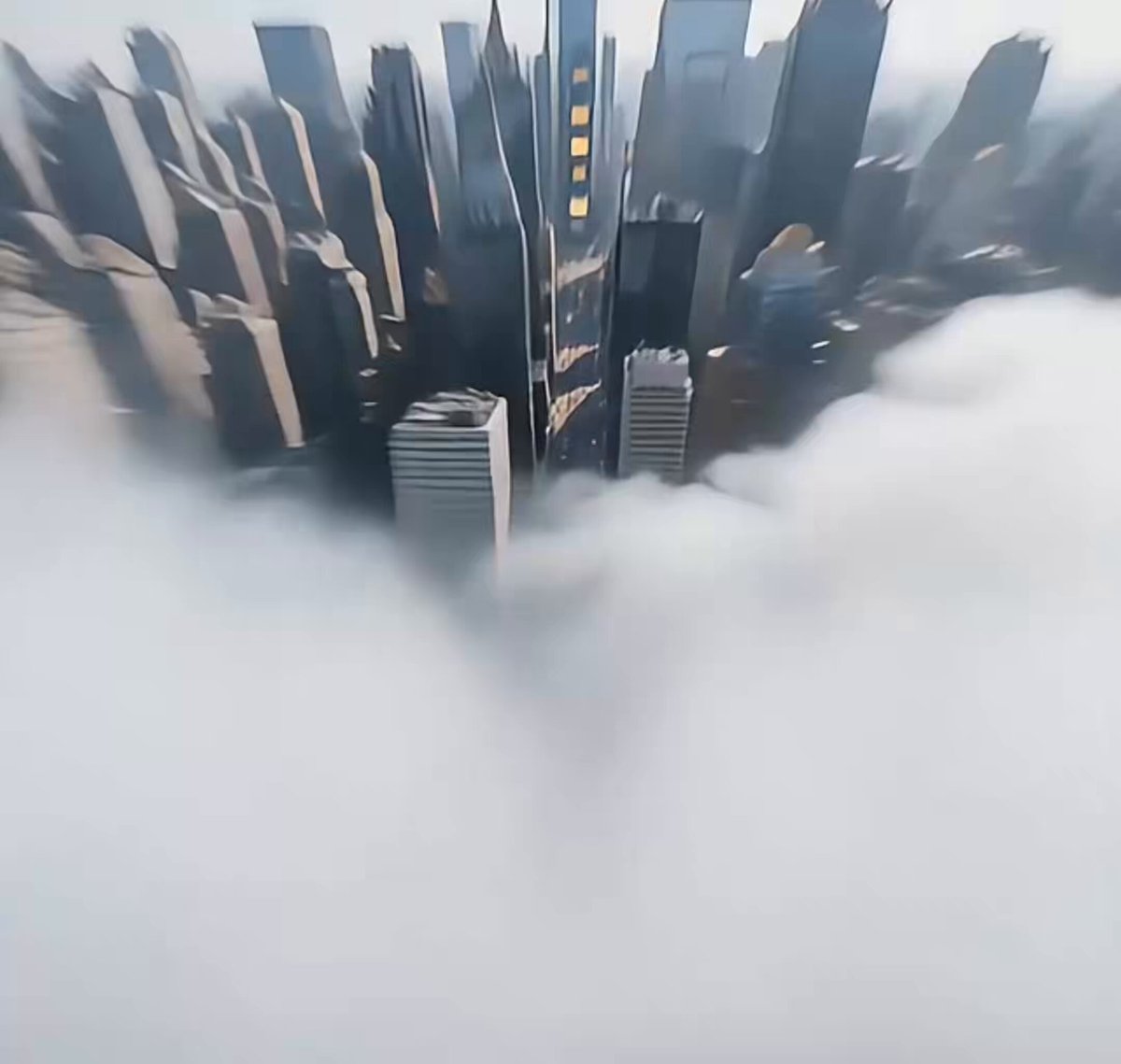 The image shows an aerial view of a city with tall buildings, including skyscrapers, surrounded by fog or clouds. The caption above the photo reads "DHC is everywhere. City lights. Subway screens. Phones. Bars. Stages. One name taking over the streets: DHC. This is not just a meme. This is a movement." which seems to be related to the Doge Head coin, possibly as part of an online campaign or social media challenge. The image captures the essence of the Doge Head coin and its popularity among internet users.