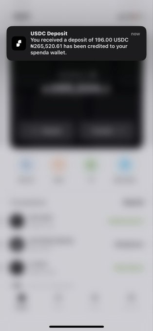 A smartphone notification displays 'USDC Deposit: You received a deposit of 196.00 USDC ₦255,520.61 has been credited to your spendr wallet.' over a blurred app interface.