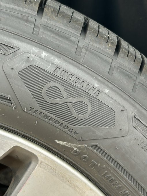 A close-up of a tire sidewall displaying the text 'IREDLIFE TECHNOLOGY' alongside an infinity symbol logo, with partial size marking 'DOT' visible.