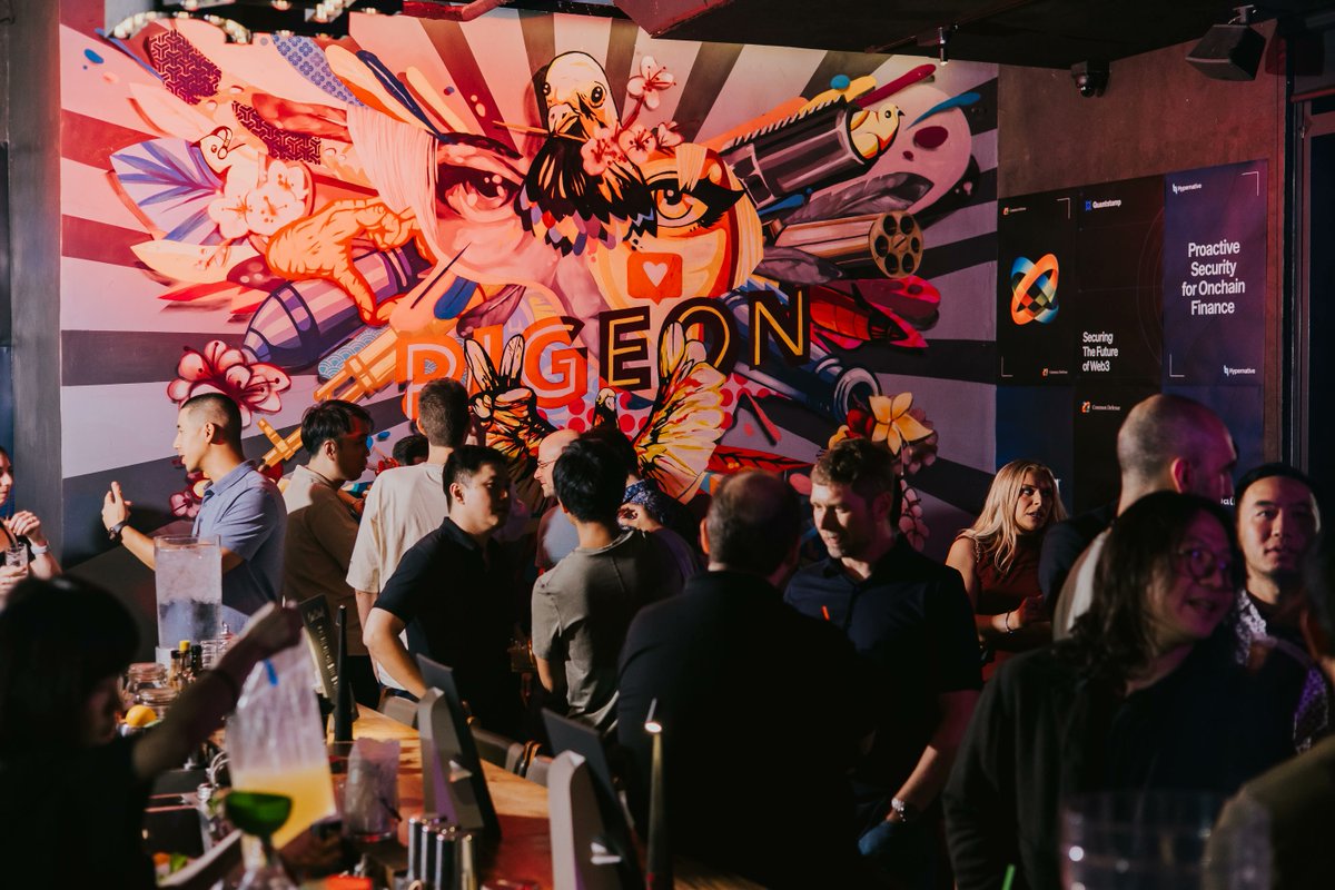 A crowded event scene in front of a vibrant mural with the word 'PIGEON' and screens advertising 'Proactive Security for Onchain Finance' by Hypernative.
