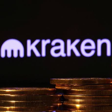 The illuminated purple 'Kraken' cryptocurrency exchange logo appears above a stack of gold-colored coins against a dark background.
