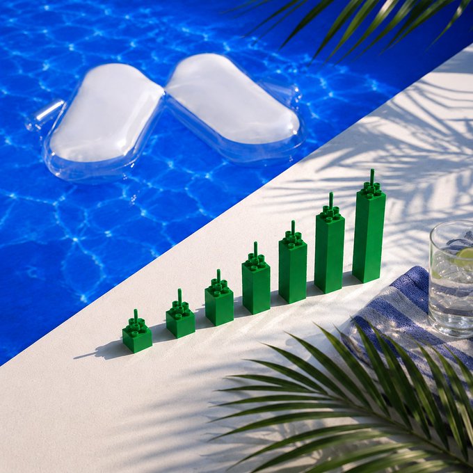 A row of green Lego-like building blocks ascend in size on a sunlit poolside, with a pair of white flip-flops floating in the blue pool nearby, visually echoing the post's theme of "stacking green" in a relaxing summer setting.