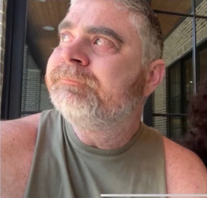 A middle-aged man with a graying beard and a frustrated, exasperated expression looks off to the side, his face contorted in an exaggerated grimace of disbelief and disappointment. His weary expression perfectly captures the mood of the post, mirroring the frustration of watching the "$Night" token value decline while the team remains committed.