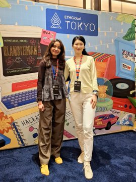 Two women smile together in front of a colorful ETHGlobal Tokyo backdrop featuring playful graphics like a cassette tape, skateboard, and "HACKATHON" chalkboard, with their matching lanyards and event badges marking the reunion noted in the caption between ETHGlobal Tokyo 2026 and 2023.