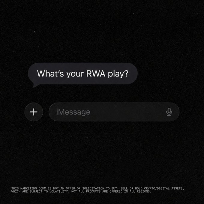A dark, textured image styled like an iMessage conversation screen displays the question "What's your RWA play?" in a chat bubble, with the standard iMessage input field below it. At the bottom, a disclaimer reads: "THIS MARKETING COMM IS NOT AN OFFER OR SOLICITATION TO BUY, SELL OR HOLD CRYPTO/DIGITAL ASSETS, WHICH ARE SUBJECT TO VOLATILITY. NOT ALL PRODUCTS ARE OFFERED IN ALL REGIONS." The image prompts viewers to share their strategy for real-world assets (RWA), a growing sector in crypto involving tokenized traditional assets.