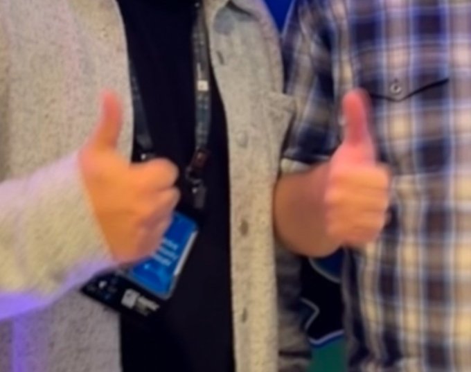 Two people give thumbs-up gestures while wearing a lanyard with an ID badge, signaling approval and support—which visually reinforces the post's enthusiastic endorsement of Chainlink as a top crypto project.