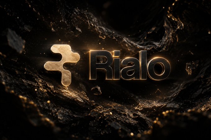 A dramatic, dark, rocky background showcases a glowing gold 3D logo featuring a stylized 'R' symbol next to the word 'Rialo'.