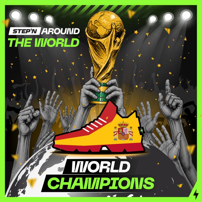 A celebratory graphic shows a golden FIFA World Cup trophy being hoisted above a crowd of raised hands, with a Spanish flag-shaped soccer cleat and the Spanish national crest displayed prominently in the foreground. The image is framed by "STEP'N AROUND THE WORLD" and "WORLD CHAMPIONS" text, tying the visual victory celebration to Spain's tournament win and the STEPN Around the World challenge that awarded a 500,000 GMT prize pool.