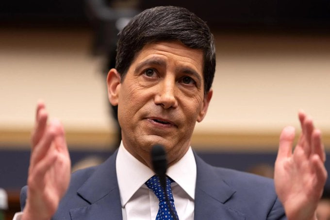A man in a dark suit and blue tie speaks with raised hands at a congressional hearing, likely relating to the post about upcoming U.S. economic data releases including PPI, CPI, and jobless claims that could shift Fed rate hike expectations.
