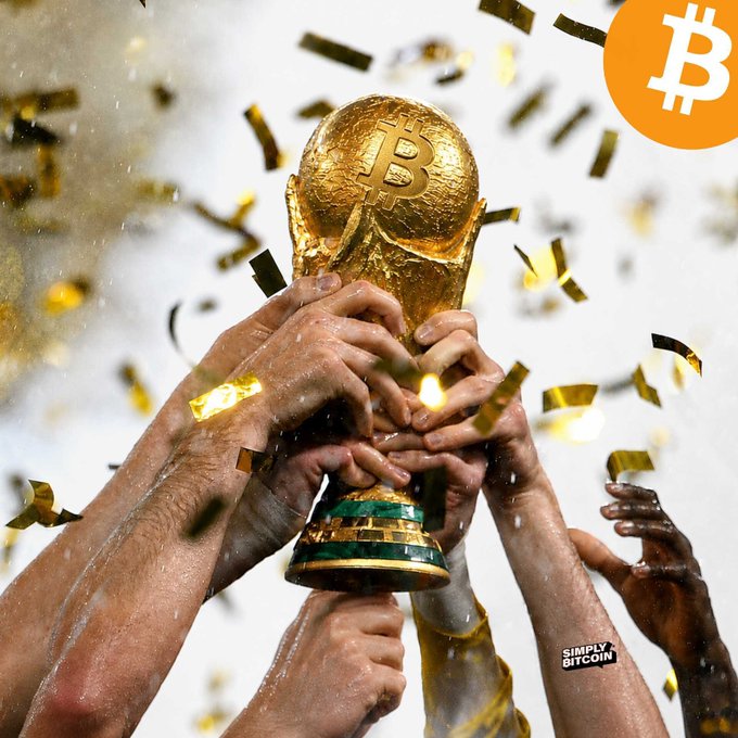 Multiple hands hoisting the FIFA World Cup trophy amid golden confetti, with an orange Bitcoin logo and 'Simply Bitcoin' watermark overlaid on the image.