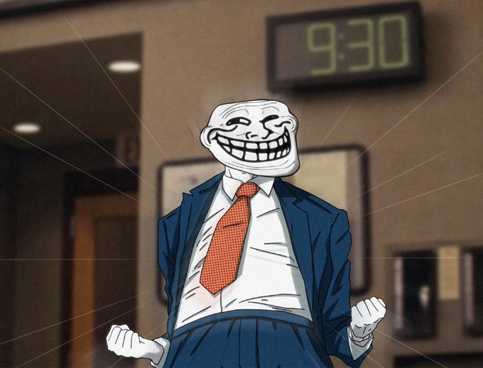 A cartoonish "Trollface" meme character wearing a blue suit and red tie stands confidently with clenched fists in an office setting, beneath a digital clock reading "9:30." The image relates to the $TROLL memecoin post by using the iconic Trollface as a visual representation of the meme token being hyped as a billion-dollar cryptocurrency.