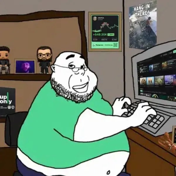 A cartoon illustration of a chubby bearded man in a green shirt using a keyboard at a computer desk with figurines and posters in the background.
