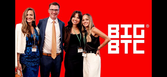 A promotional photo of four people (two women, one man, one younger woman) posing together against a red background with a large white 'BTC INC' logo on the right.