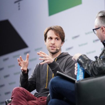 Ethereum researcher Justin Drake gestures animatedly during a panel discussion, with the partial "ALTER" text visible on a banner behind him, as he likely shares his concerns about AI potentially threatening the cryptographic foundations of blockchains like Ethereum.