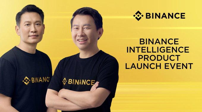 Binance Intelligence Product Launch Event promotional image showing two men wearing black Binance t-shirts against a yellow background.