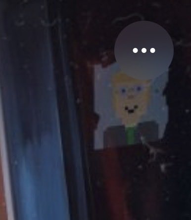 A blurry, low-light image shows a pixelated cartoon figure with a speech bubble containing "..." against a dark, indistinct background. The image appears to be a snapshot of a new Beeple NFT artwork, consistent with the post celebrating @realstonkbroker being featured in Beeple's work two days in a row, likely referencing $StonkBroker.
