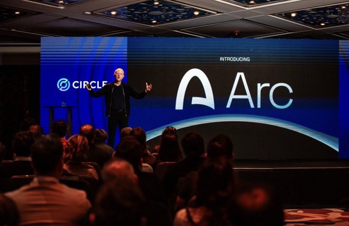 A man presents on stage at a Circle event introducing 'Arc,' standing in front of a large screen displaying the Circle logo and 'INTRODUCING Arc' text, with an audience visible in the foreground.