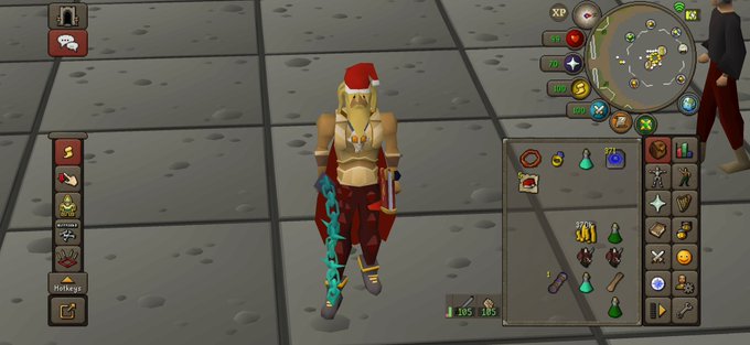 A screenshot from the video game Old School RuneScape showing a female character wearing a red Santa hat and holding a glowing blue weapon.
