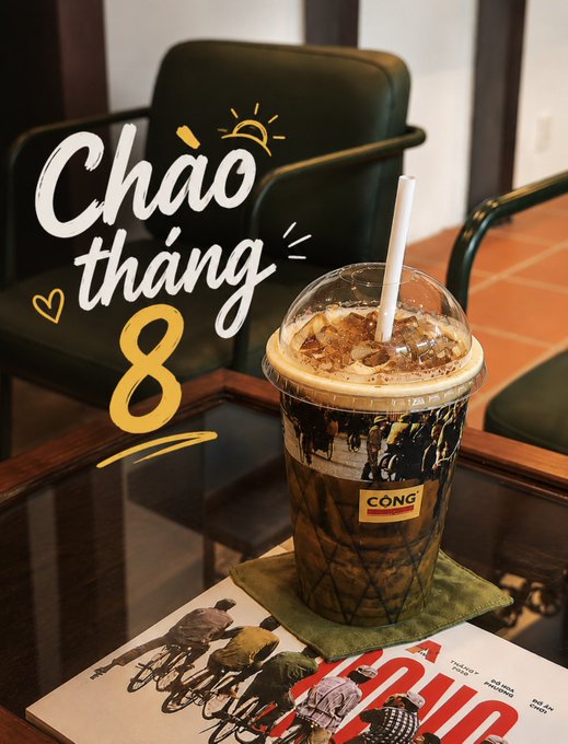 An iced coffee from 'CONG' sits on a table next to a magazine, with the stylized text 'Chào tháng 8' (Hello August) overlaid in white and yellow.