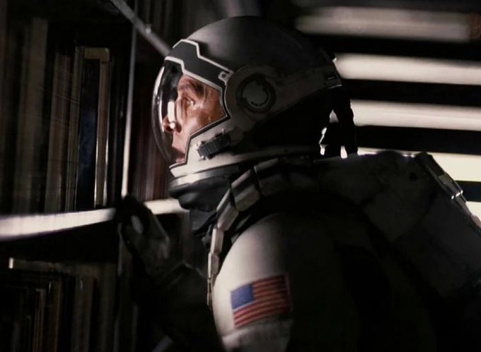 An astronaut in a spacesuit with an American flag patch looks up in awe at a bookshelf, resembling the iconic Interstellar film scene. The image humorously reflects the feeling of regret and longing after missing out on profits from a round-trip trade.