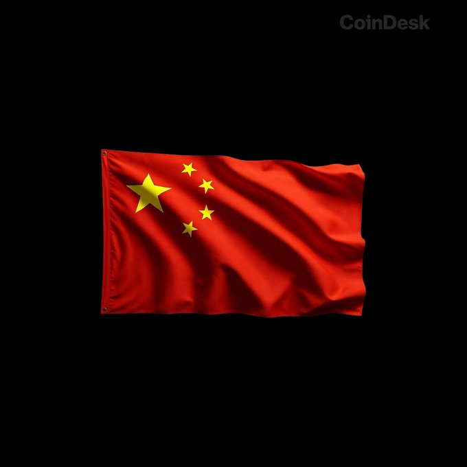 A waving Chinese flag appears against a black background, with a faint “CoinDesk” watermark in the upper-right corner. It illustrates the post’s report of a China-led Asian stock selloff, alongside declines in Japan’s Nikkei and Bitcoin and a surge in oil prices.