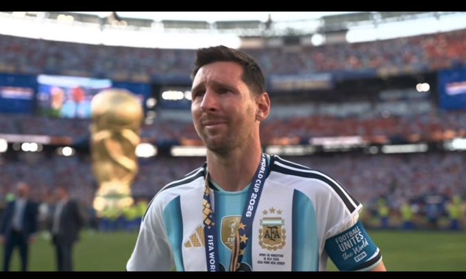An emotional Lionel Messi in his Argentina jersey and 'Football Unites the World' captain's armband, standing on the pitch with the FIFA World Cup trophy visible in the background.