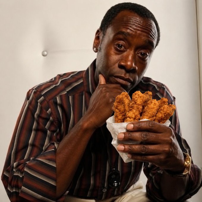 An older Black man wearing a striped button-up shirt thoughtfully holds a paper-wrapped serving of fried chicken.
