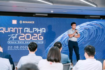 A speaker addresses an audience at the "Quant Alpha Talk 2026" event held on 22.08.2026, co-hosted by Binance and SSI, with the tagline "Where Data meets Markets" displayed on the backdrop.

The image directly illustrates the post's description, showing a Binance event where the speaker's presentation reflects the company's engagement with the intersection of traditional finance and quantitative trading, as highlighted in the caption.