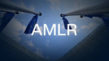 The image shows European Union flags displayed against a blue sky with the text "AMLR" prominently overlaid in white letters. AMLR likely refers to the EU's Anti-Money Laundering Regulation, which aligns with the post's discussion of EU financial surveillance policies, including capped cash transactions, crypto identification requirements, and efforts to close VPN loopholes in age-verification systems.