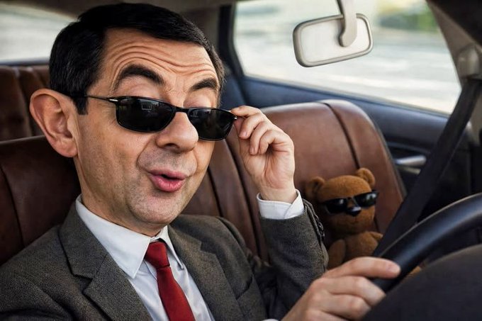 A man in a suit and sunglasses sits behind the wheel of a car alongside a teddy bear also wearing sunglasses, with a rearview mirror visible above. The playful "cool" duo image paired with the caption about cash payouts and earnings highlights a victorious, "good start" vibe for August — like cruising confidently into a successful month.