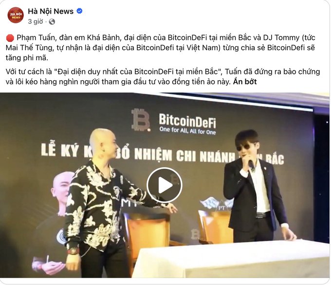 The image shows a Facebook post from "Hà Nội News" featuring a video still of two men at a BitcoinDeFi "Lễ Ký Kết Bổ Nhiệm Chỉ Nhánh" signing ceremony, with text identifying them as Phạm Tuấn (Northern representative) and DJ Tommy Mai Thế Tùng (self-proclaimed Vietnamese representative) promoting the crypto project BitcoinDeFi.