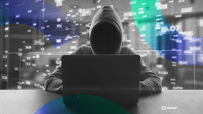 A hooded, anonymous figure works on a laptop surrounded by floating crypto price tickers and data overlays, with a "decrypt" watermark visible in the corner—visually reinforcing the post's warning about SparkKitty malware stealing crypto wallet seed phrases from app stores.