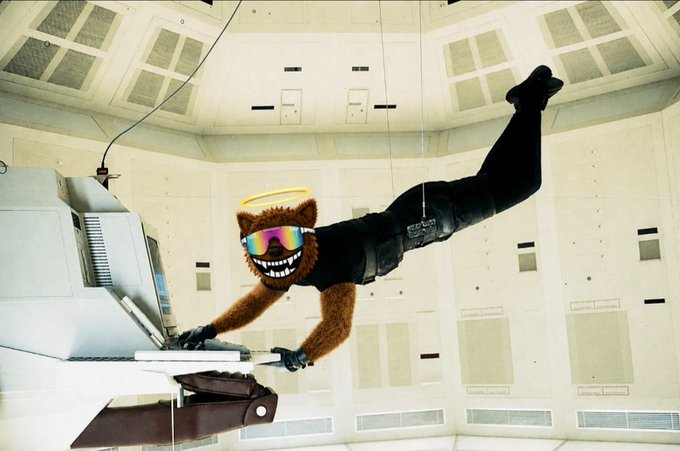 A costumed mascot character with a wide, toothy grin, reflective sunglasses, a halo, and brown furry arms appears to float or skydive through a futuristic white room while holding a brown wallet, seemingly themed around the "$FUZZY" token referenced in the post. The image captures the surreal, larger-than-life energy of the "Fuzzy Bear" crypto mascot, visualizing the post's excitement about a mind-blowing project ("#freefuzzy") that keeps growing beyond expectations.