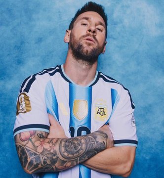Lionel Messi, wearing Argentina's iconic light blue and white striped jersey, poses with arms crossed and a confident smirk against a blue backdrop, embodying the star power behind the trader's smart bet on Argentina over Egypt.