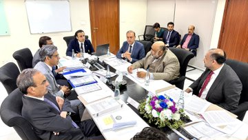 A formal meeting of Pakistani officials, including the Prime Minister, convenes around a conference table to discuss the establishment of the Pakistan Virtual Assets Regulatory Authority (PVARA), with documents, laptops, and a floral centerpiece visible on the table, reflecting the country's strategic push toward integrating Bitcoin and crypto into its long-term 2047 economic vision.