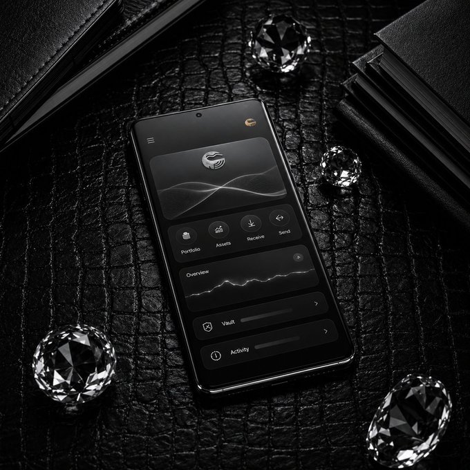 A sleek black smartphone displaying a crypto wallet app interface with Portfolio, Assets, Receive, Send, Vault, and Activity options, resting on a dark textured surface alongside a black wallet and scattered diamonds.
