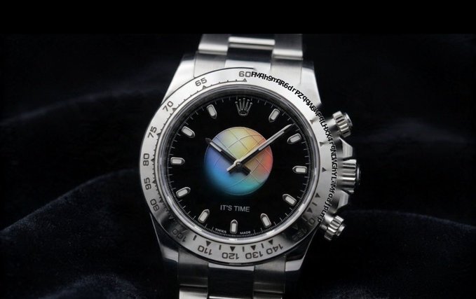 This image shows a Rolex Daytona watch with a colorful globe on the dial and the text "IT'S TIME." The visible text on the bezel, "60RMAh9qR6drPZq9AEWPOLHXX4PONDWGhYLMfoaj pump," seems to be a reference to the "CA" mentioned in the post, possibly indicating a "cosmic astronaut" or a similarly themed watch.