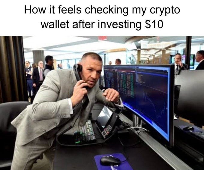 A meme with the caption "How it feels checking my crypto wallet after investing $10" shows a man in a suit intensely focused at a trading desk, speaking on a phone while staring at a monitor displaying financial charts and data, humorously exaggerating the seriousness of checking a small crypto investment.

The image relates to the post "Any profit is a profit" by mocking how small crypto investors treat even tiny investments with the intensity and urgency of a professional Wall Street trader.