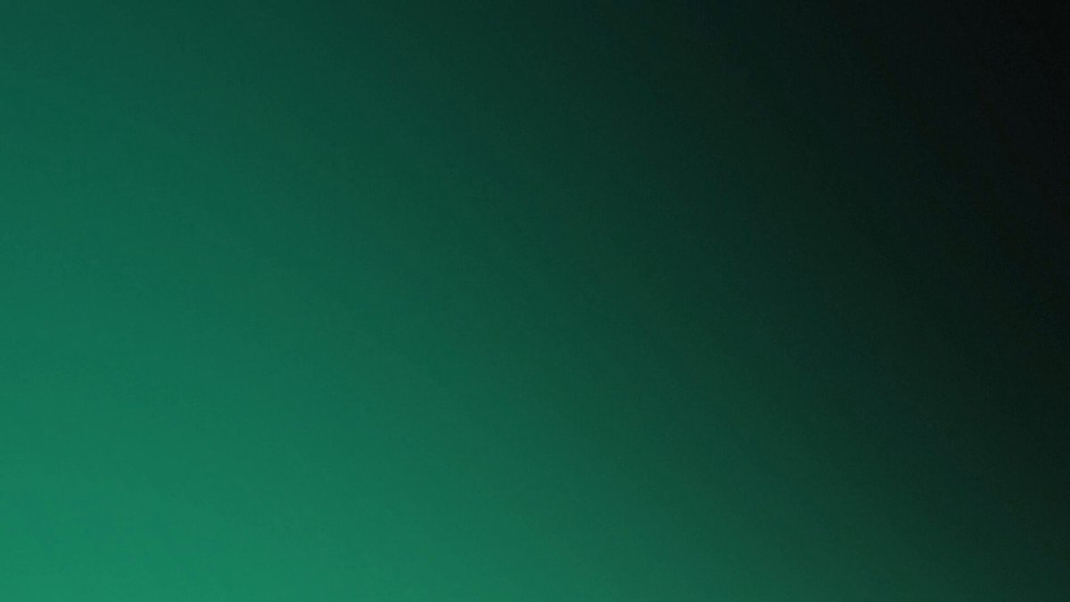 The image features a large, green gradient background that transitions from light to dark shades of green. The gradient appears to be a gradient of blue or teal with some black elements mixed in for contrast. The image does not contain any text or other objects, making it a simple and clean visual composition.